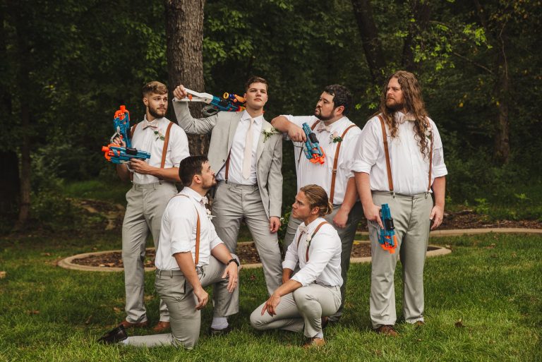 Groomsmen pose with nerf guns