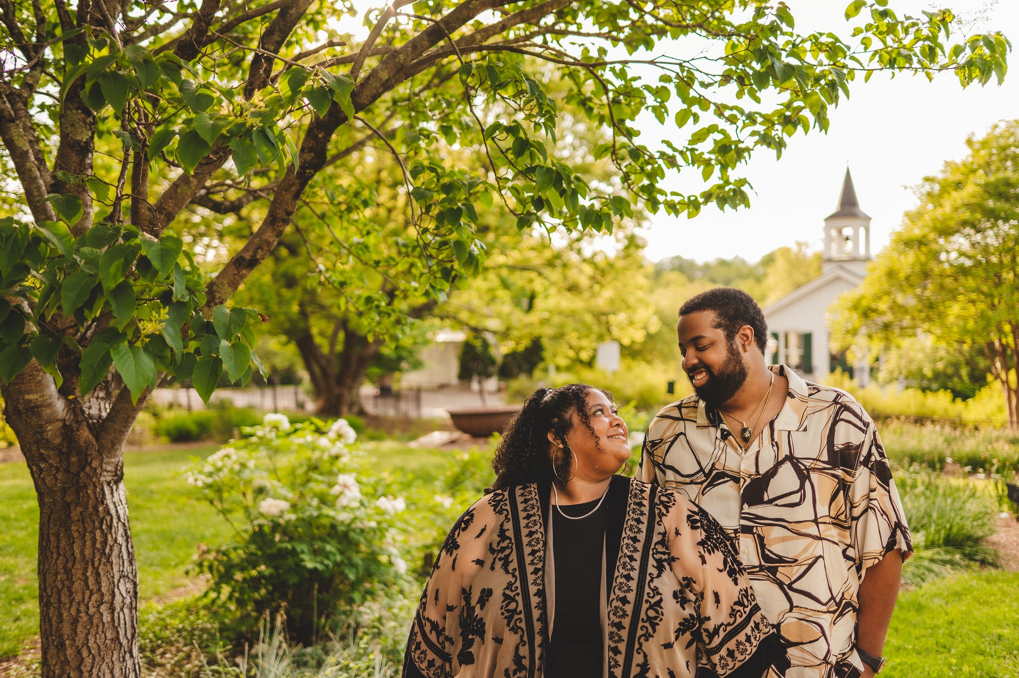 Couple poses in Old City Cemetery smiling.