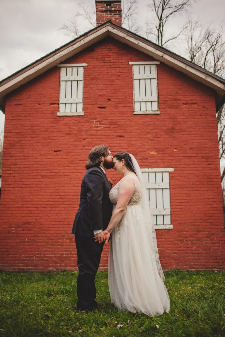 Bride and Groom in front of red brick house