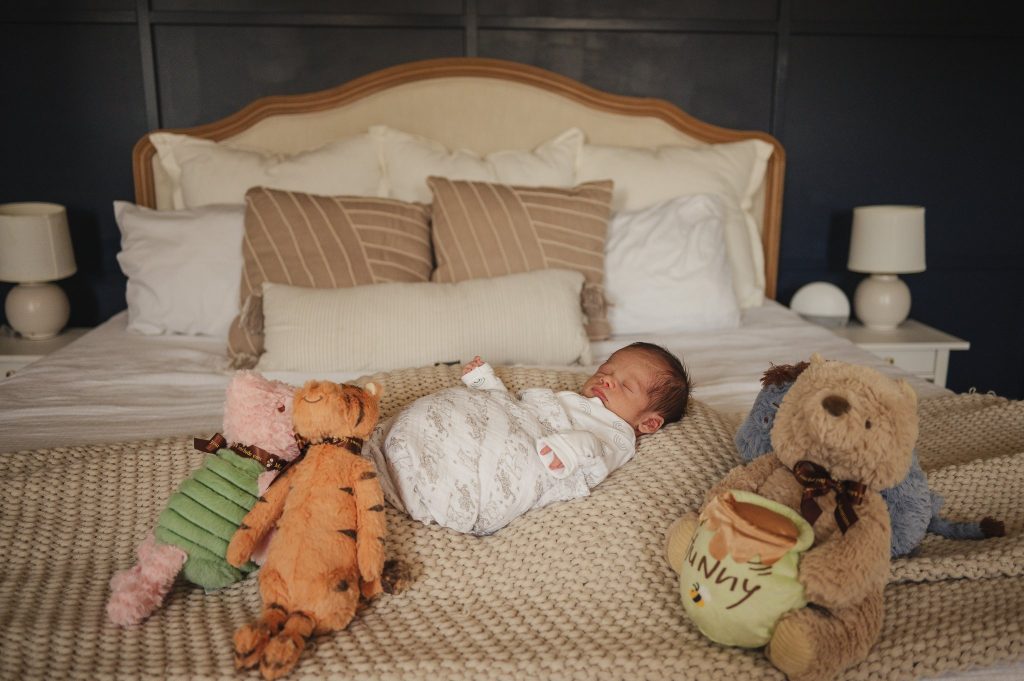 Colton Sleeps with Winnie the Pooh stuffed animals