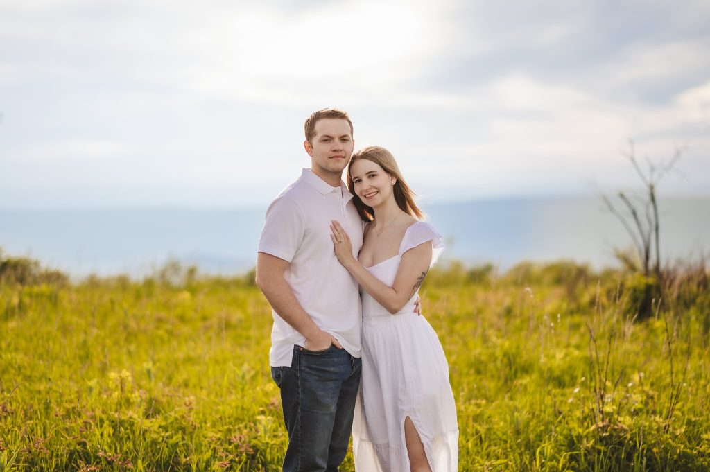 A couple wearing white in a field
