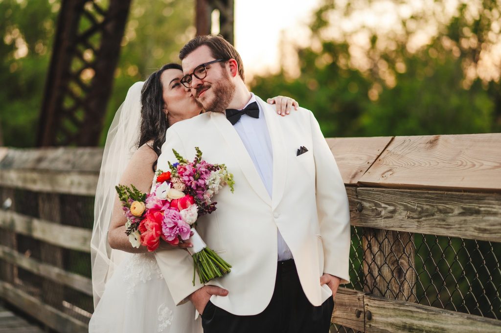 Wife kisses her husband on the cheek