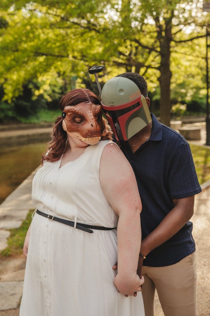 A couple dressed as a dinosaur and Boba Fett